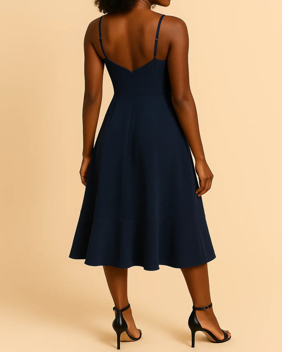 Back design of ADKN’s sustainable ruffle midi dress in navy blue recycled fabric.