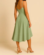 Back design of ADKN’s sustainable ruffle midi dress in sage green recycled fabric.