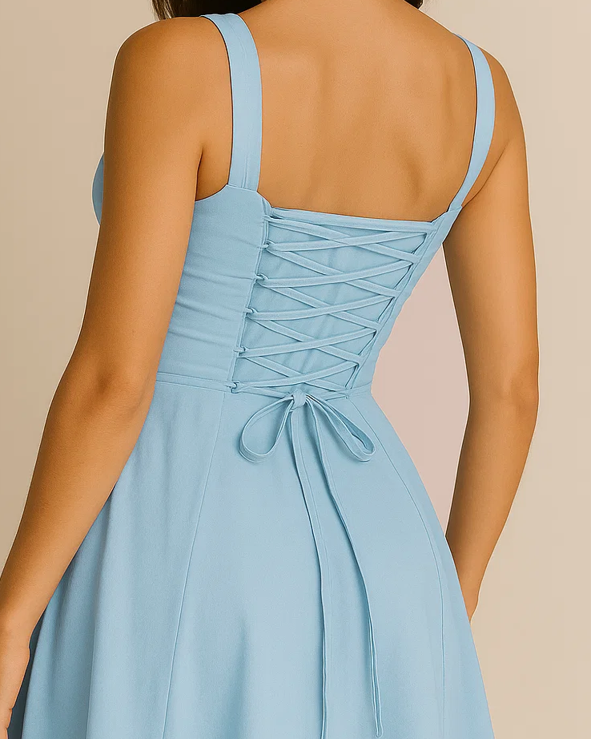 The Heidi corset milkmaid midi dress in pastel blue, made from sustainable recycled polyester. Shown from the back view. Ethically made in London by ADKN