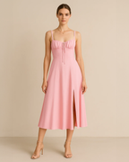 Heidi corset milkmaid midi dress in pastel pink, crafted from recycled polyester. Vegan, ethical fashion for wedding parties. Ethically made by ADKN in London