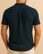 Back view of men’s navy ribbed shirt with stand collar