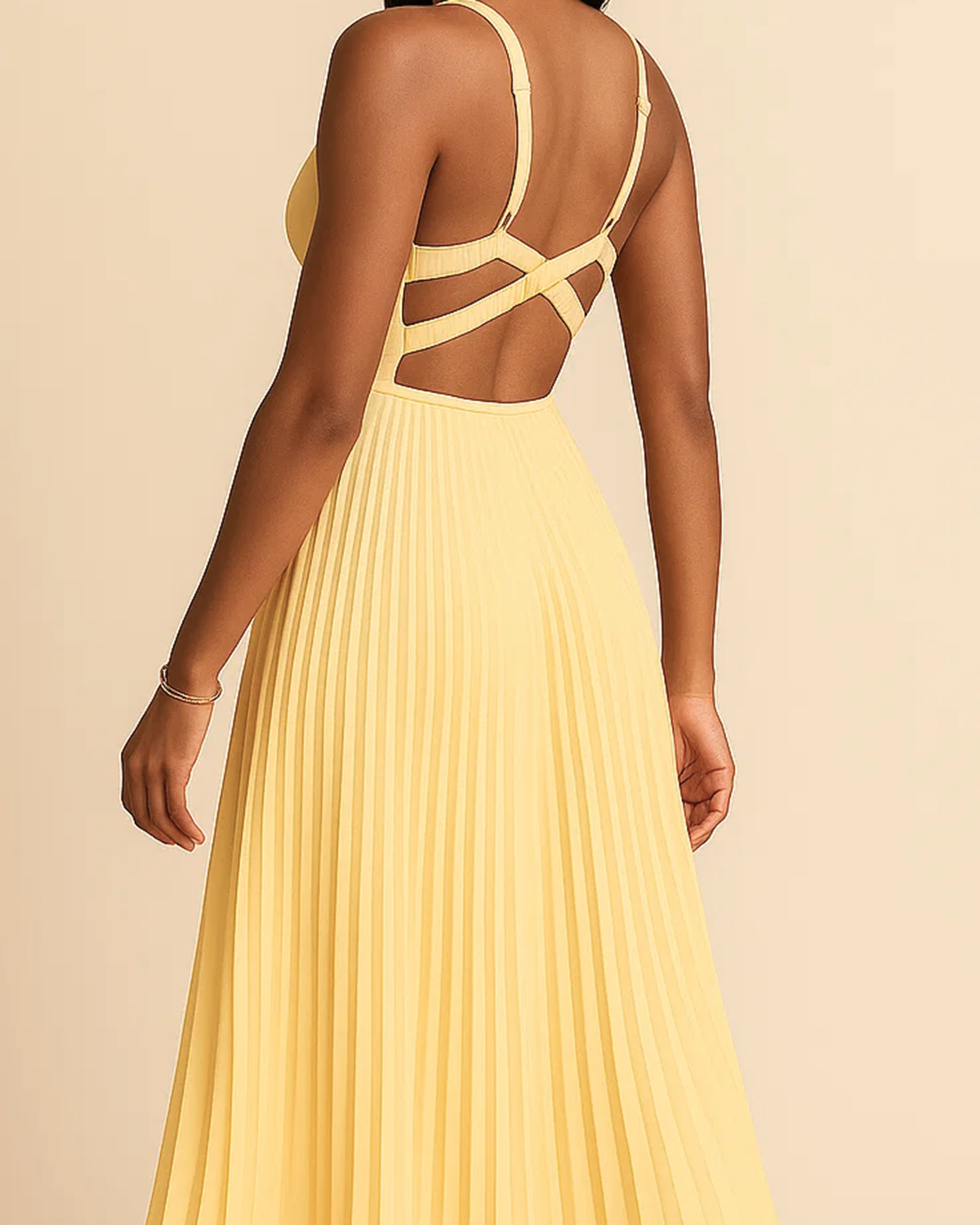 The Soleil pleated midi dress in butter yellow, made from sustainable recycled polyester. Shown from the back view. Ethically made in London by ADKN