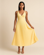Soleil pleated midi dress in butter yellow, crafted from recycled polyester. Vegan, ethical fashion for wedding guest. Ethically made by ADKN in London