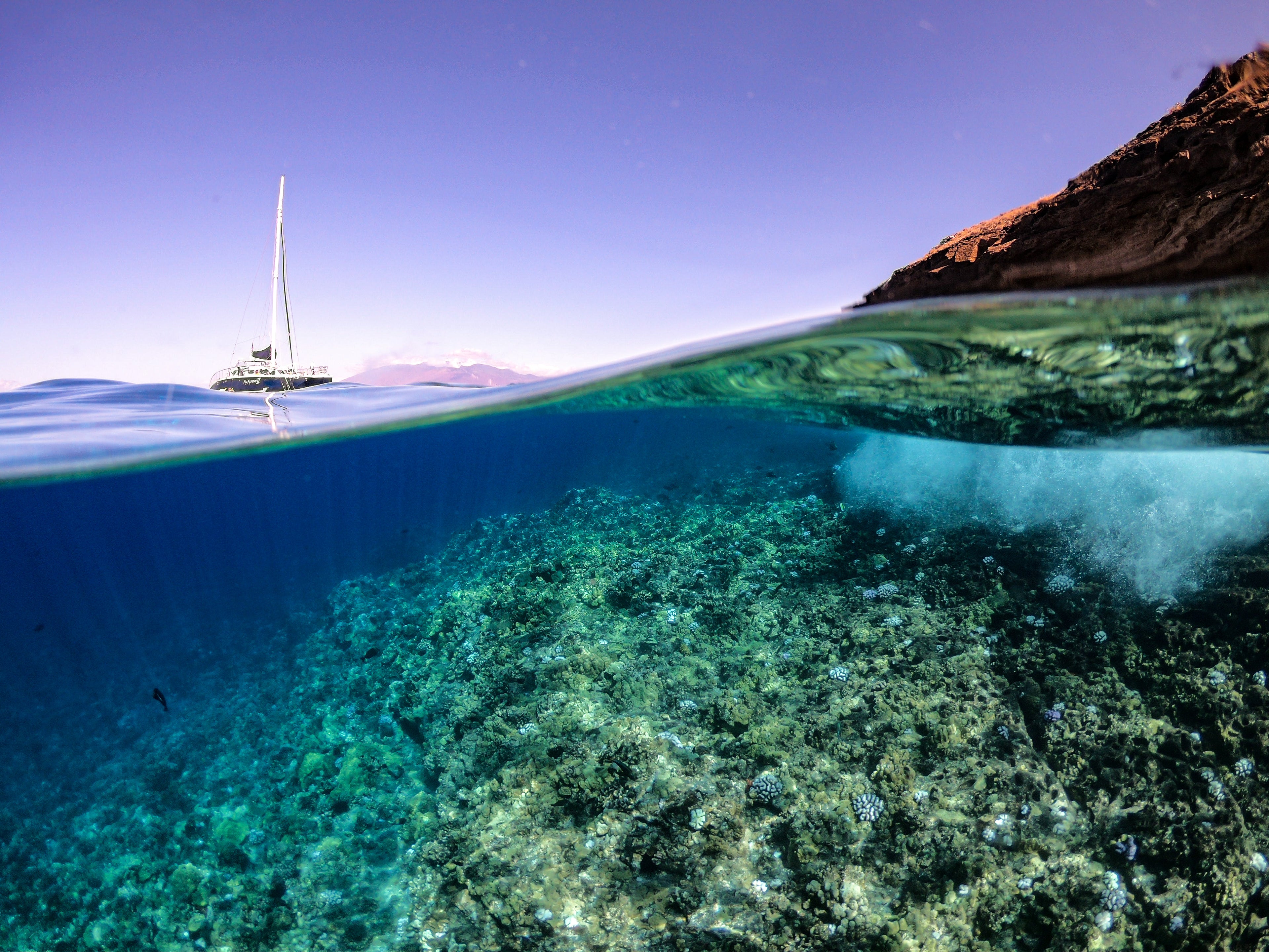 Image of clear water with a boat in the background