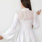 Back of designer white fit & flare recycled chiffon classy blouse with high neck and key hole ethically made in UK by ADKN