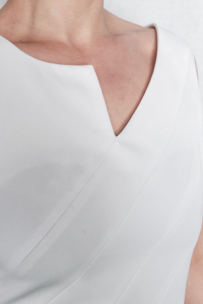 Detail of v-neck sleveless white recycled vest casual day dress Eirene by ADKN ethically made in UK from recycled plastic bottles