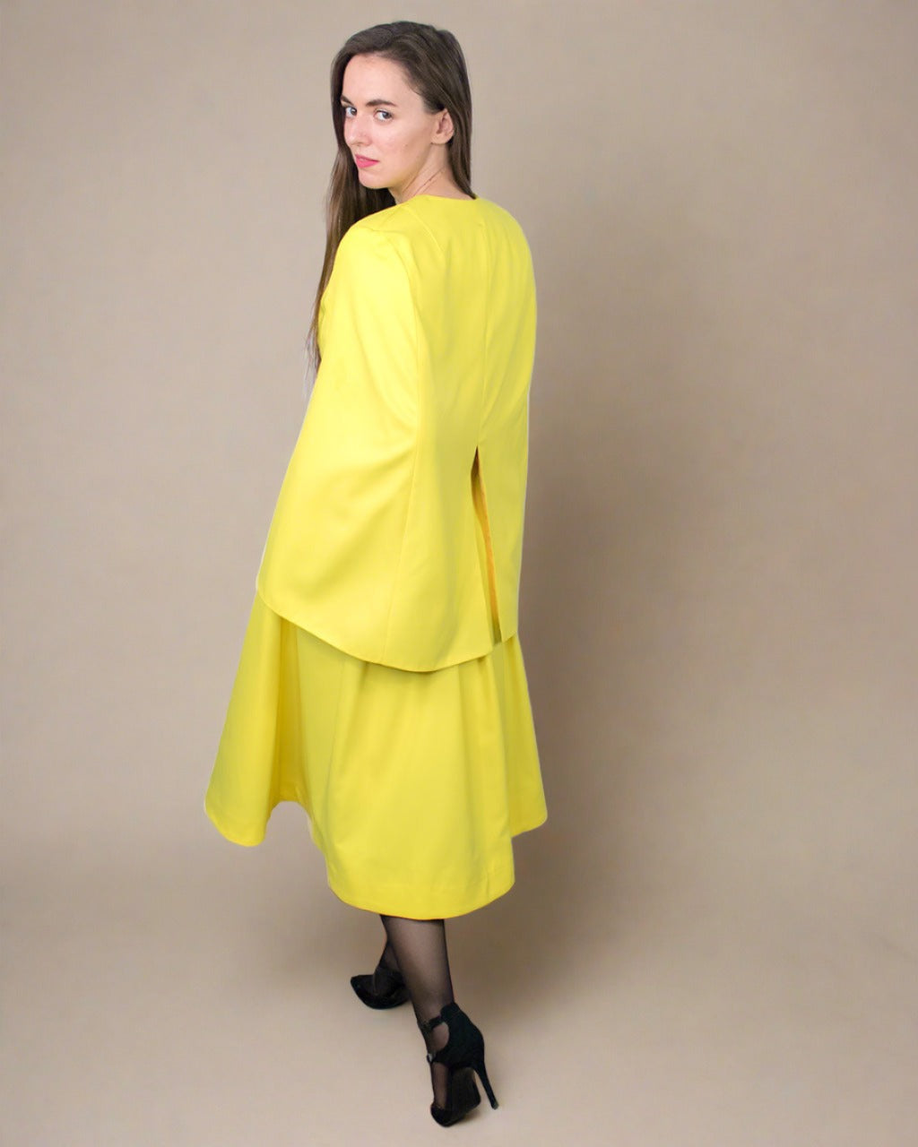 Back view of Amee Raincoat longline yellow mustard waterproof gabardine cape spring trench coat by ADKN