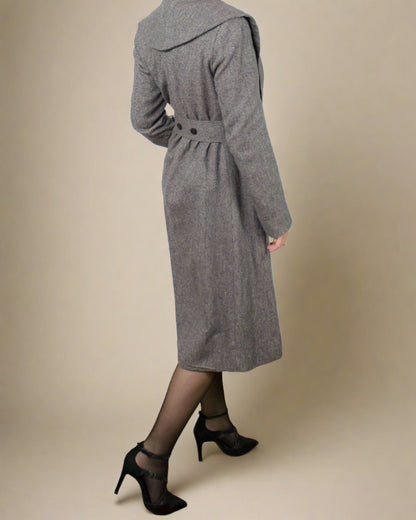 Back view of maxi skater tailored fit and flare coat by ADKN with belt and corozo buttons detail and a wide collar
